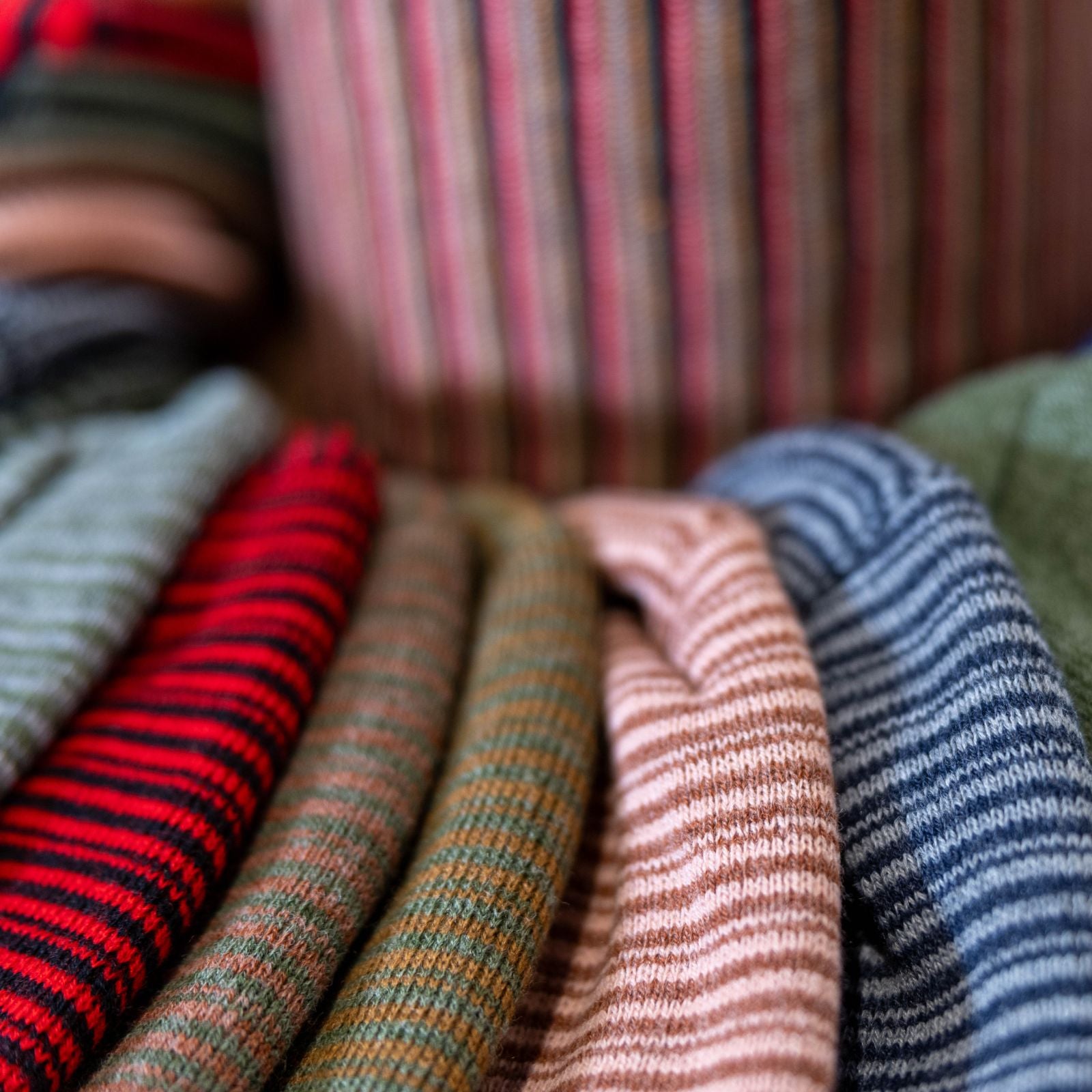 Multiple Beanie Flex hats are on display. Multiple colors and patterns can be shown. These hats are fully customizable.