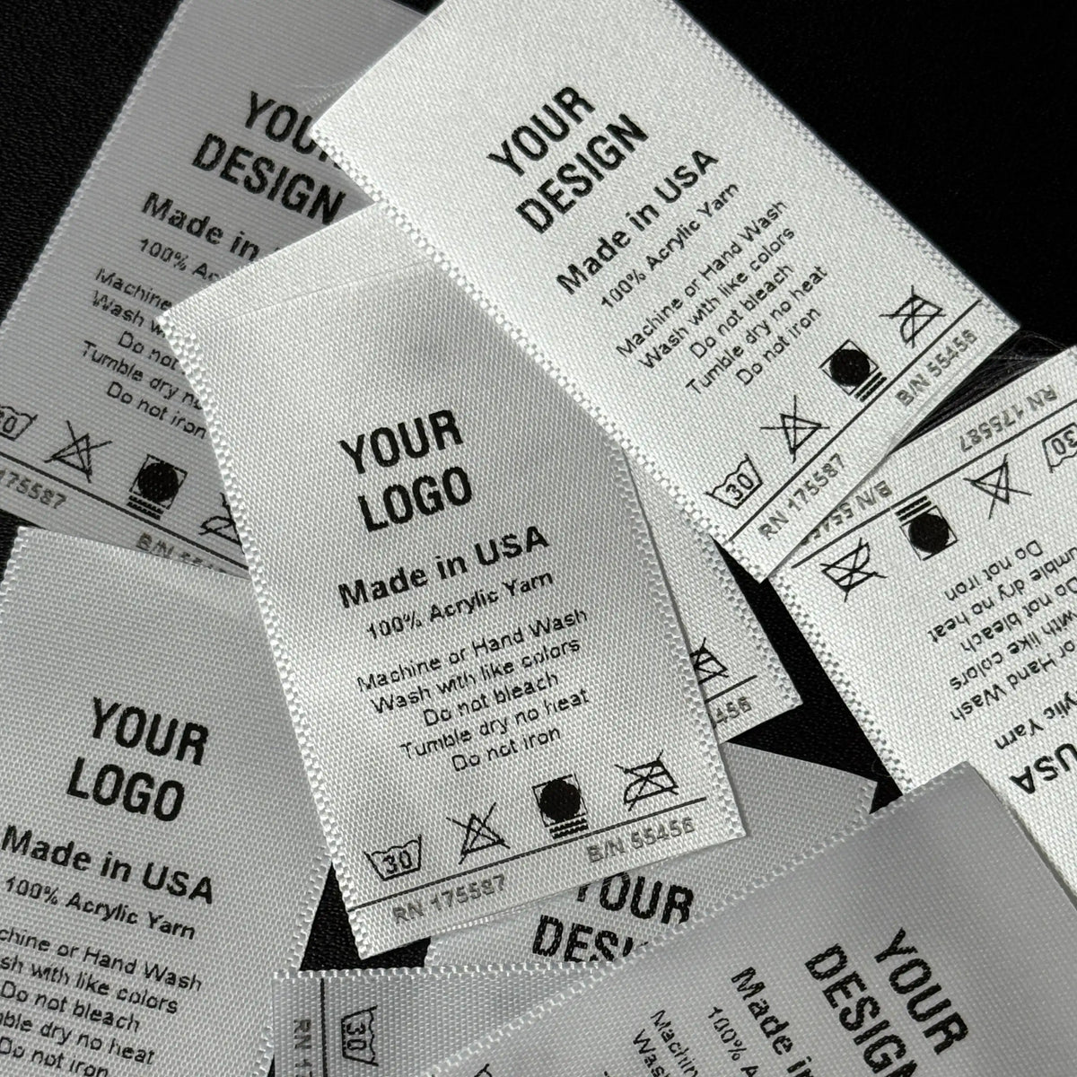 Fabric labels with customizable text and symbols on a black background